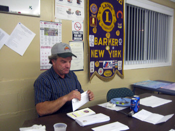 Photo:President Carl Stoloski stuffs envelopes at the recent Blind Seals Meeting