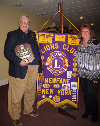 Lion George Bridgeman holds his Melvin Jones Plaque with  Newfane Lions President Denise Chadwick.