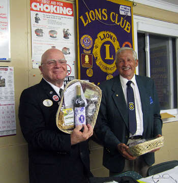Lion District Governor John Haak receives a gift from Barker