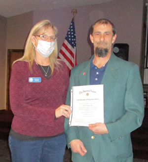 Barker Lion and American Legion Member Pam Rider presents a 
Certificate to Barker Lions President Tim Leising